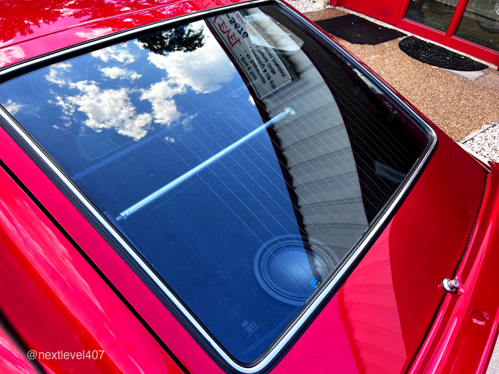 Red Datsun Car Interior Alpine Subwoofer in Rear Window, Next Level Orlando