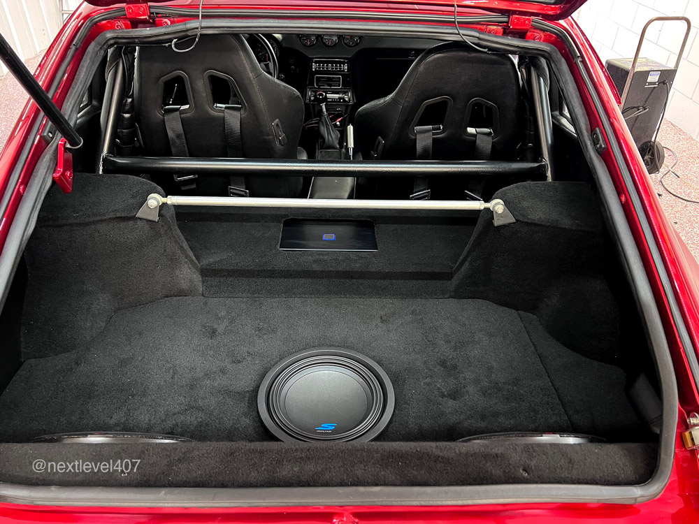 Red Datsun Car Interior Alpine Subwoofer in trunk, Next Level Orlando