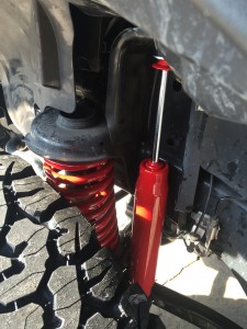 Red accented springs and shocks installed on 2015 Jeep Wrangler Unlimited.