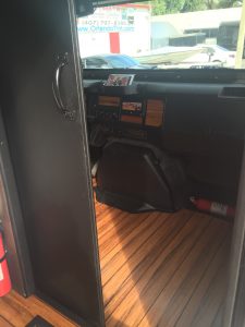 Wood floors extended to drivers cockpit with wood accented dash