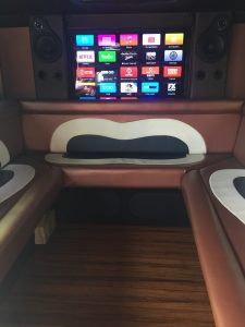 TV and custom seats in armored truck limo