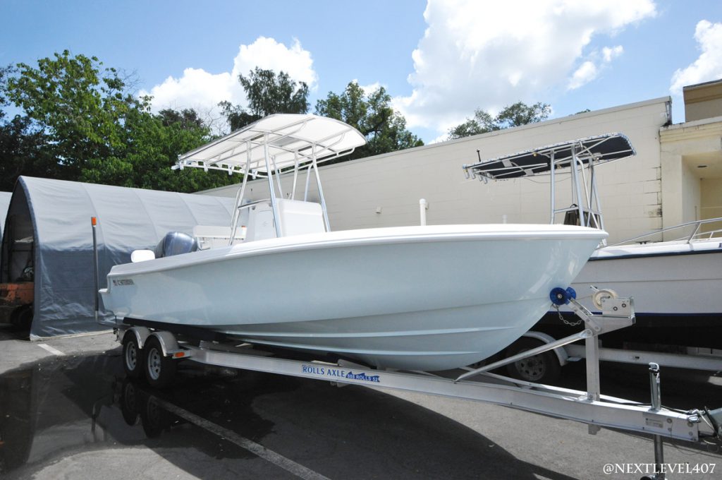 White Contender-Boat-On-Rolls-Axle-Trailer-Full-Profile
