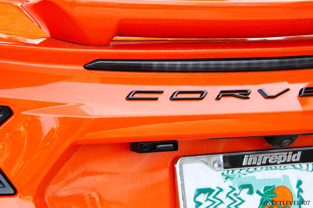 Orange-Corvette-K40-Speed-Trap-Sensor-Custom-Install-Next-Level-Front-Bumper-Store-Front-Extreme-Close-Up-Rear-Trunk-License-Plate-Laser-Sensor-Intrepid