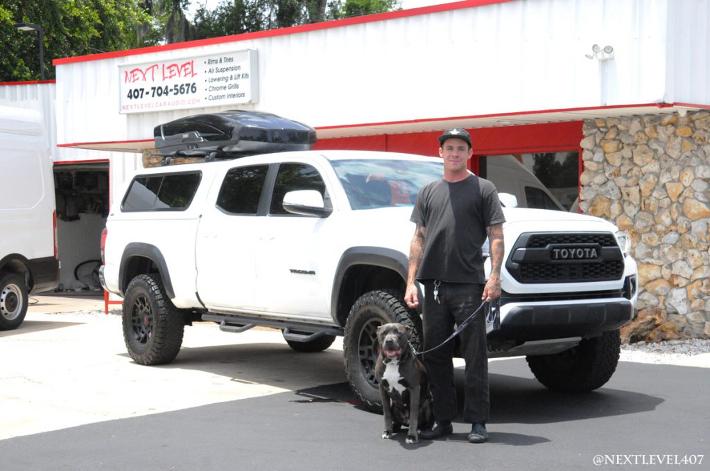 White-Toyota-Tacoma-Custom-Install-Next-Level-Inc-Store-Front-Full-Profile-Pro-BMX-Rider-Rockstar-Energy-Drink-Dog