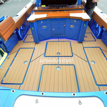 inside shot of a Blue Hydrasport with tan seadek flooring and brown leather seats with SD engraved